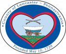 County seal of Lancaster PA featuring a covered wagon, containing text County Of Lancaster - Pennsylvania, Founded May 10, 1729